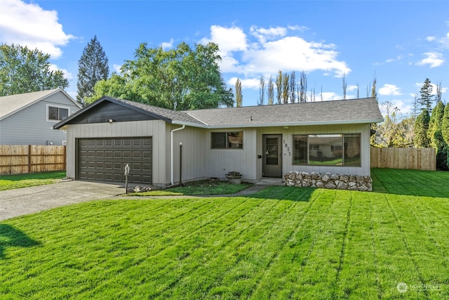 single story home featuring a garage and a front lawn