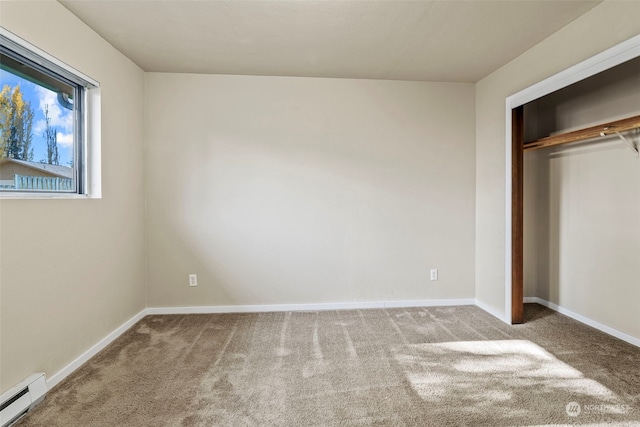 unfurnished bedroom featuring a closet, light carpet, and a baseboard heating unit