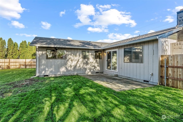 rear view of house with a lawn and a patio area