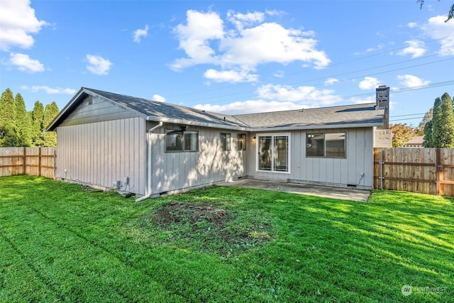 back of property with a patio and a lawn