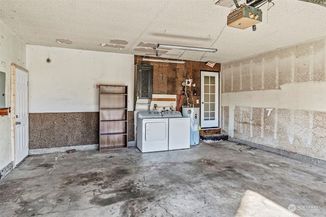 garage featuring electric panel, water heater, washer and clothes dryer, and a garage door opener