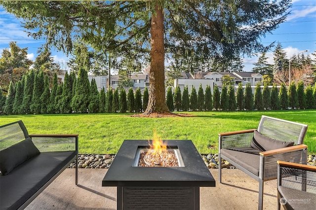 view of yard with an outdoor fire pit and a patio area