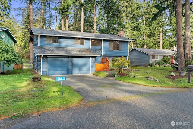 view of front of property with a front yard and a garage