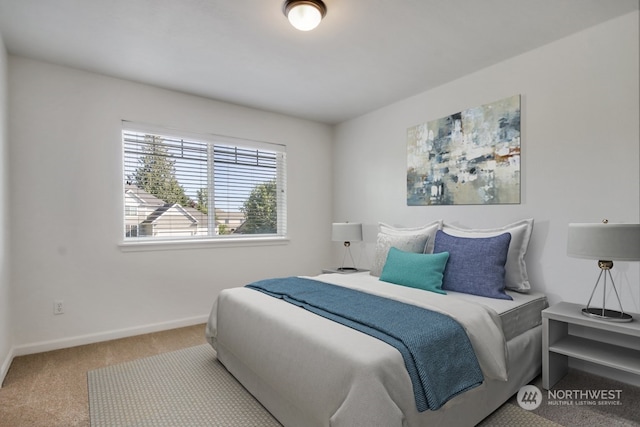 bedroom with baseboards and light colored carpet