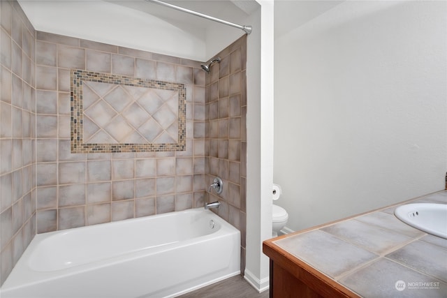 bathroom featuring toilet, washtub / shower combination, and vanity