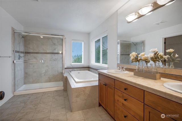 bathroom with tile patterned floors, vanity, and separate shower and tub