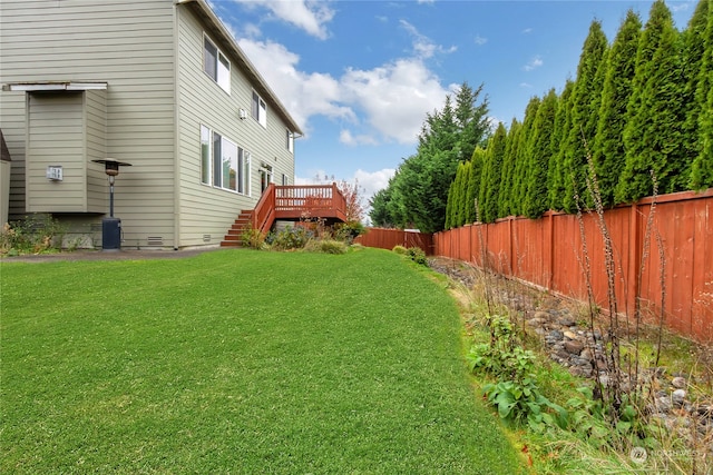 view of yard with stairs, a fenced backyard, and a wooden deck