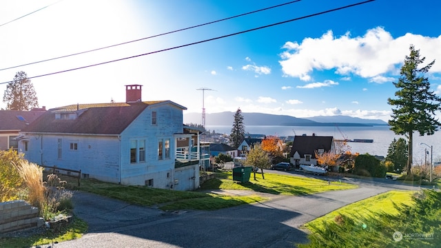 view of home's exterior with a water and mountain view