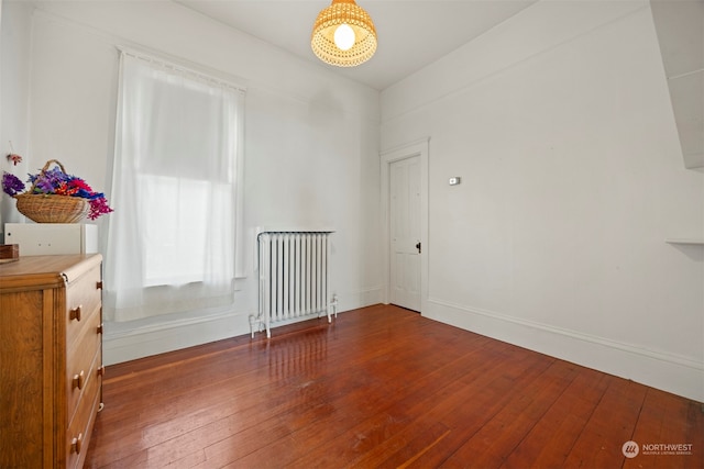 spare room with radiator and wood-type flooring