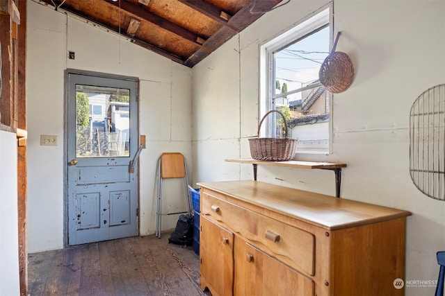 doorway to outside with lofted ceiling with beams, dark hardwood / wood-style flooring, and wood ceiling