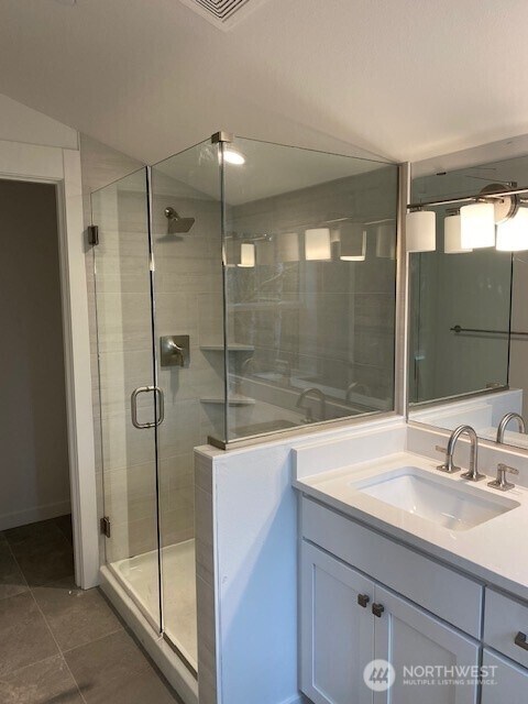 full bathroom featuring a shower stall, vanity, and tile patterned floors