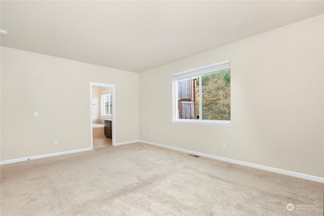 empty room featuring light carpet