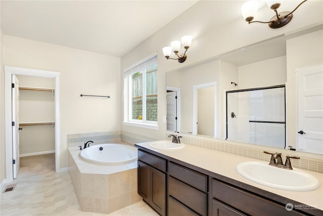 bathroom featuring tile patterned floors, vanity, and separate shower and tub