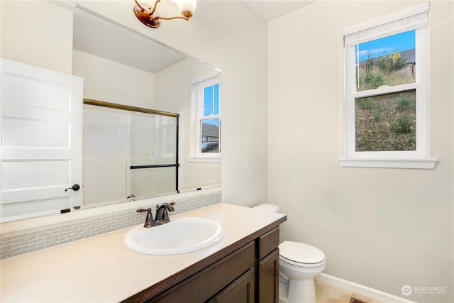 bathroom with decorative backsplash, vanity, toilet, and an enclosed shower