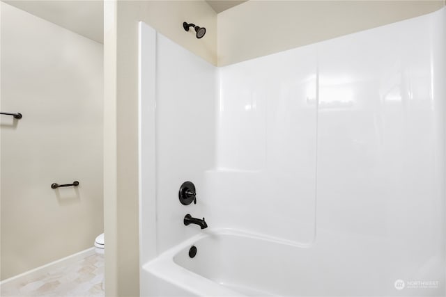 bathroom with bathtub / shower combination and toilet