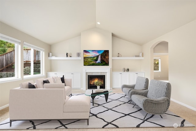 living room featuring light colored carpet and vaulted ceiling