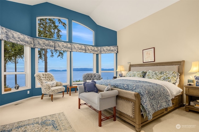 carpeted bedroom featuring a water view and vaulted ceiling