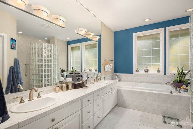 bathroom featuring tile patterned floors, vanity, and shower with separate bathtub