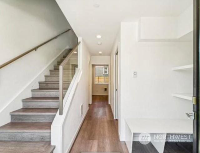 stairway with hardwood / wood-style floors