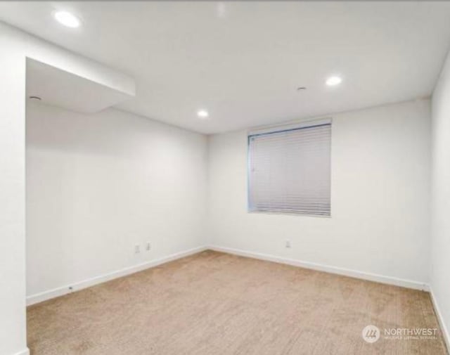 spare room with light colored carpet