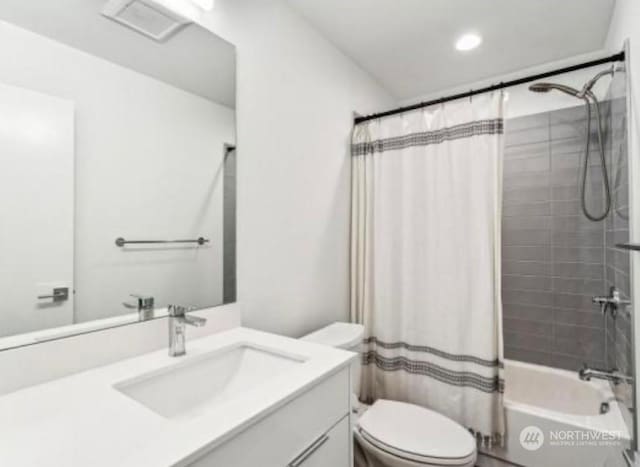 full bathroom with shower / bath combo, vanity, and toilet