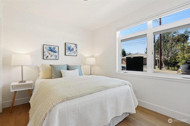 bedroom with hardwood / wood-style flooring