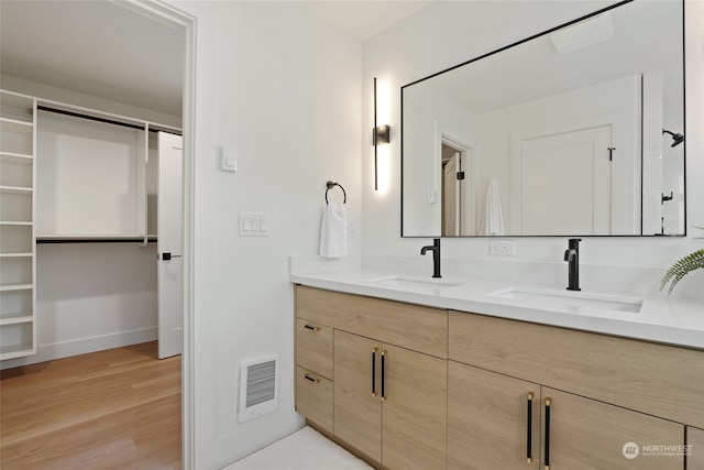 bathroom with vanity, hardwood / wood-style flooring, and heating unit