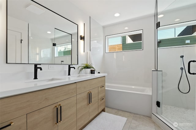 bathroom with tile patterned floors, vanity, separate shower and tub, and a wealth of natural light