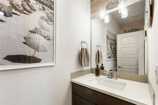 bathroom featuring decorative backsplash and vanity