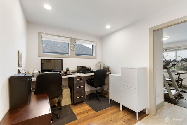 office area with light hardwood / wood-style floors and a wealth of natural light