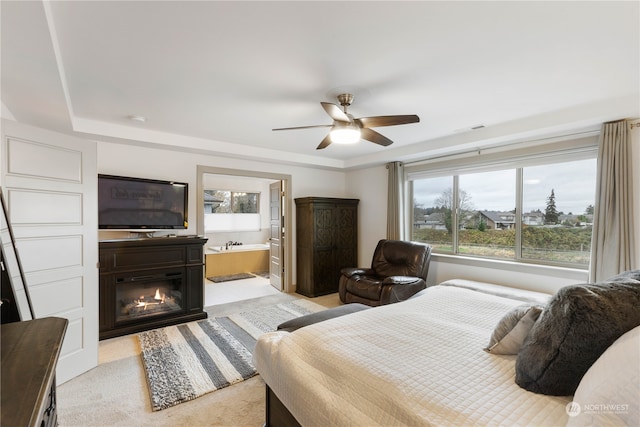 carpeted bedroom with connected bathroom and ceiling fan