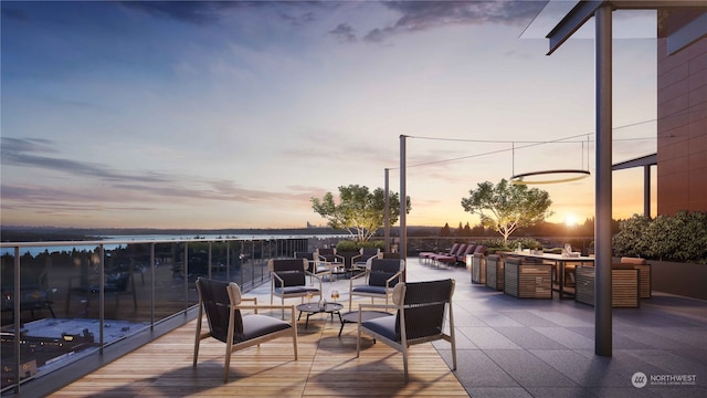 patio terrace at dusk featuring an outdoor hangout area and a water view