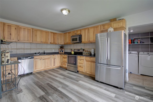 kitchen featuring separate washer and dryer, light brown cabinetry, stainless steel appliances, and light hardwood / wood-style floors