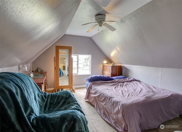 bedroom featuring a textured ceiling, carpet floors, vaulted ceiling, and ceiling fan