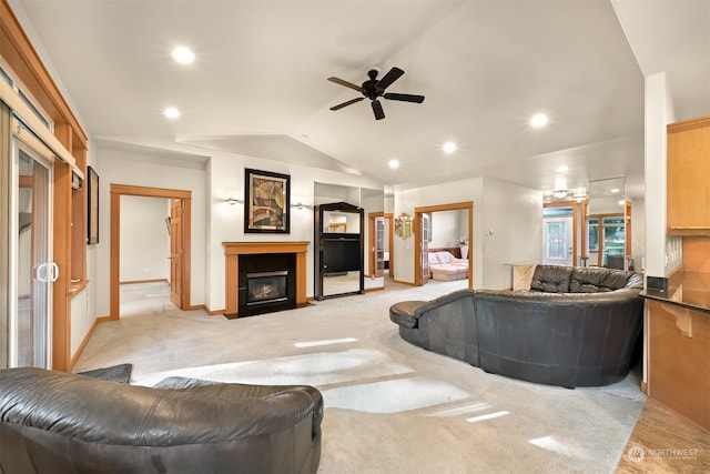 carpeted living room with vaulted ceiling and ceiling fan