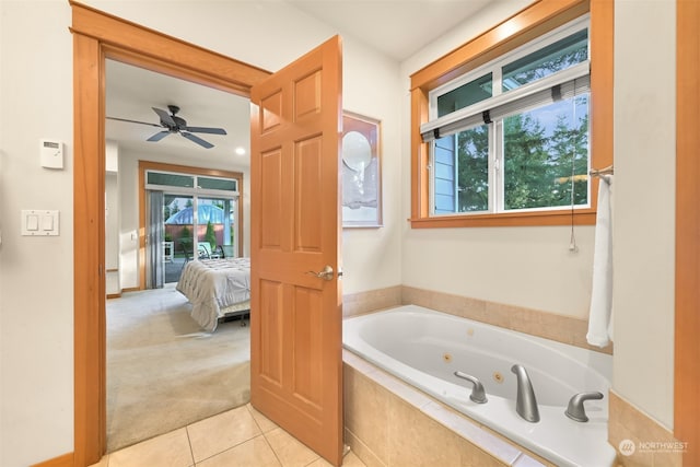 bathroom with a relaxing tiled tub, plenty of natural light, ceiling fan, and tile patterned flooring