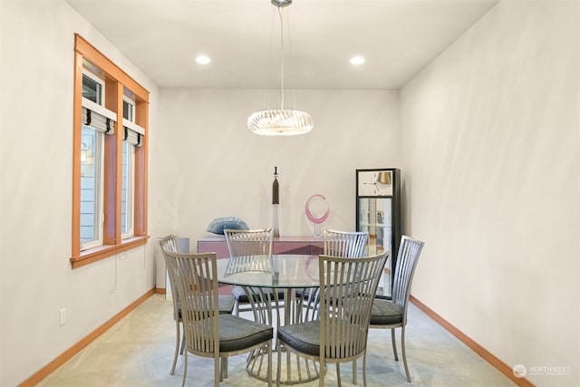 carpeted dining area featuring an inviting chandelier