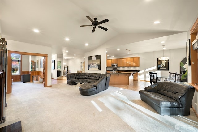 carpeted living room with vaulted ceiling and ceiling fan