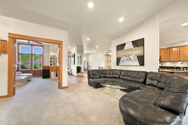 living room with sink and light colored carpet