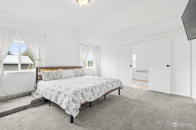 bedroom with carpet floors and connected bathroom