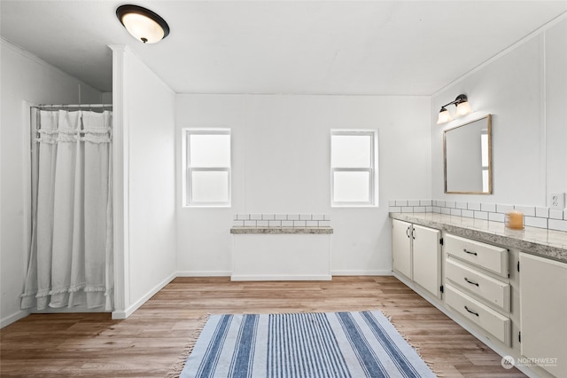 bathroom featuring a wealth of natural light, vanity, and wood-type flooring