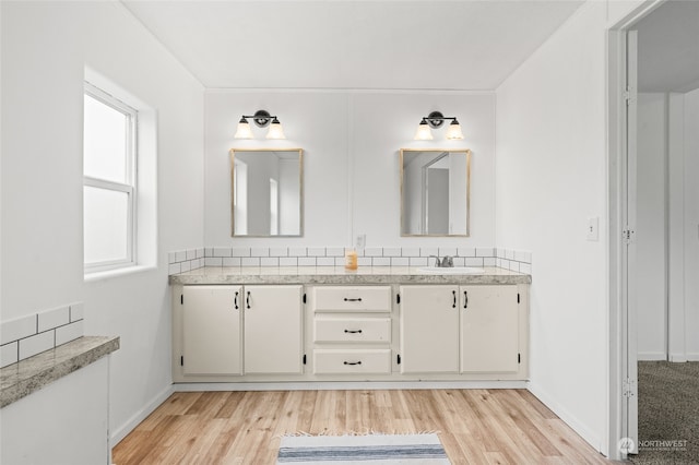 bathroom featuring plenty of natural light, wood-type flooring, and vanity