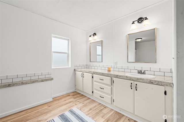 bathroom with hardwood / wood-style floors and vanity