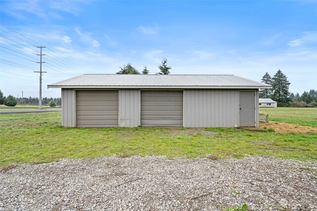 garage featuring a lawn