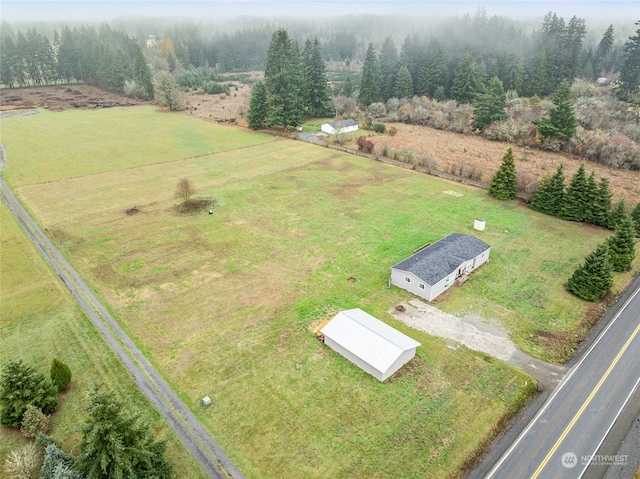 birds eye view of property with a rural view