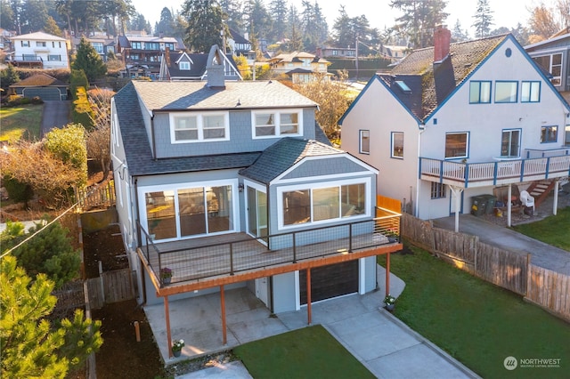 rear view of house featuring a patio area, a garage, and a yard