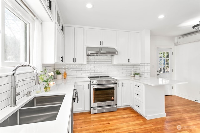 kitchen with light wood-type flooring, stainless steel appliances, extractor fan, sink, and white cabinets