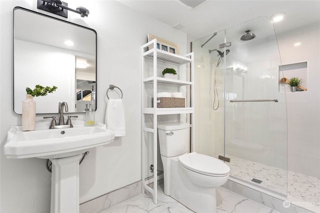 bathroom featuring toilet and a shower with door