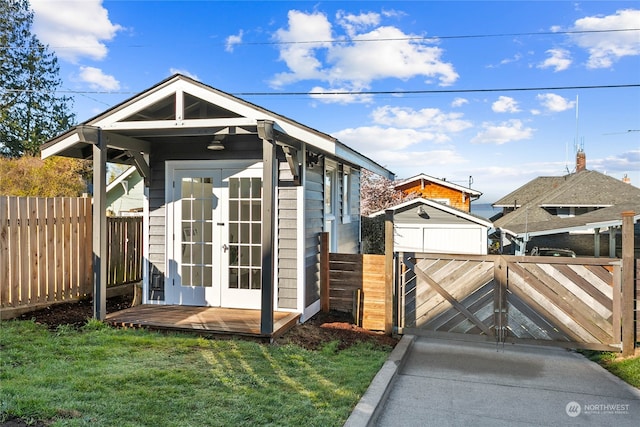 view of outbuilding featuring a lawn and french doors