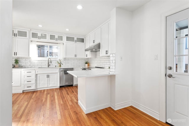 kitchen featuring stainless steel dishwasher, light hardwood / wood-style floors, white cabinetry, and sink